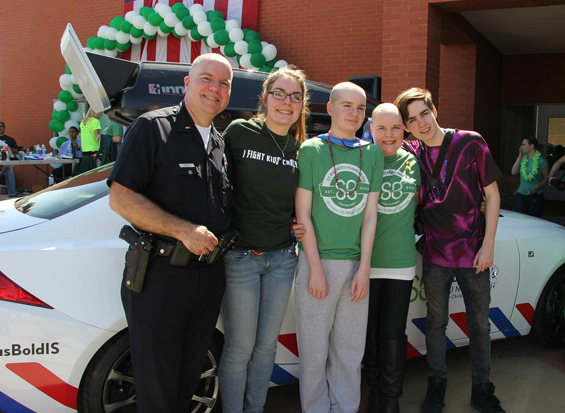 Doyle family in front of St. Baldrick's themed Lexus Bold IS