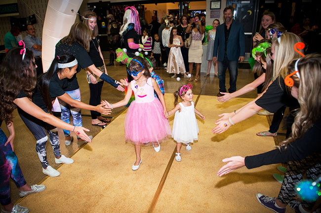 Kids walk the gold carpet at the Miracle Party for families impacted by childhood cancer