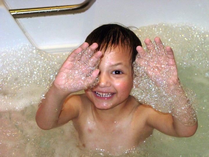 Micah plays in a bubble bath