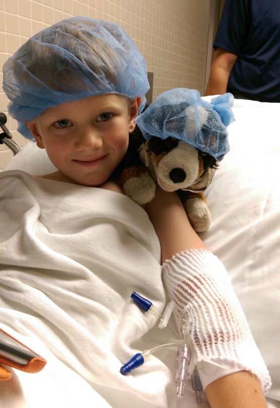 Will holds his stuffed dog, Harley, before going into surgery