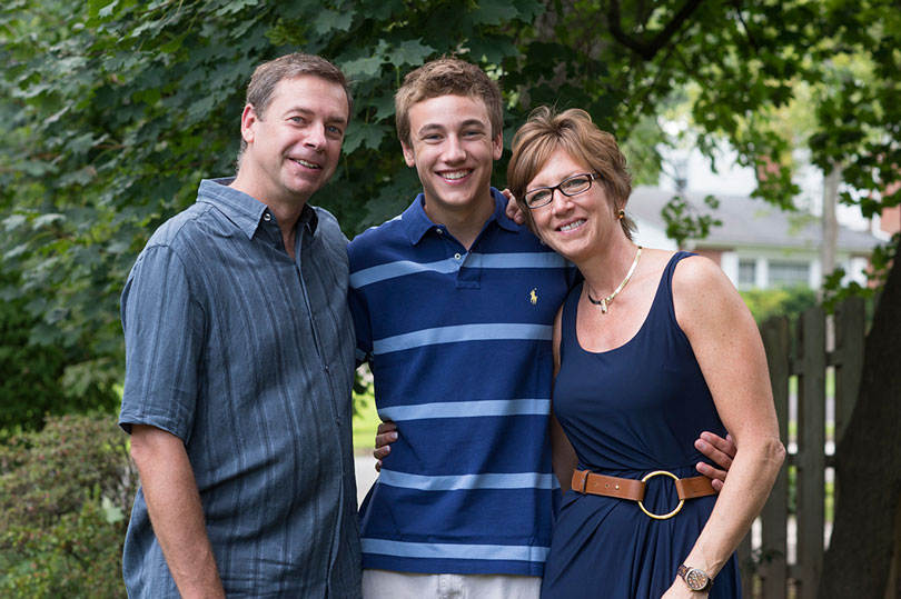 Ambassador Aaron smiles with his parents, Dana and Greg