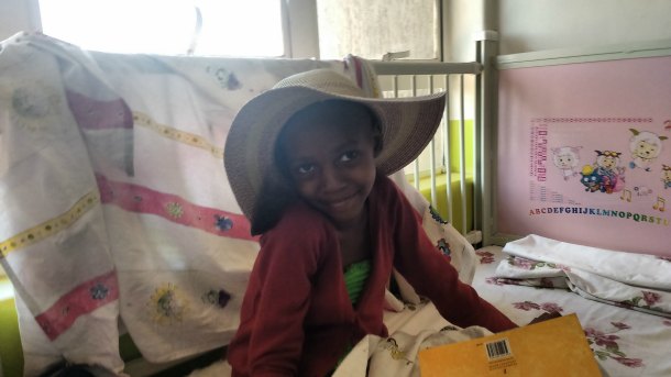 Shakina, one of Dr. Lubega's patients with kidney cancer, smiles for the camera