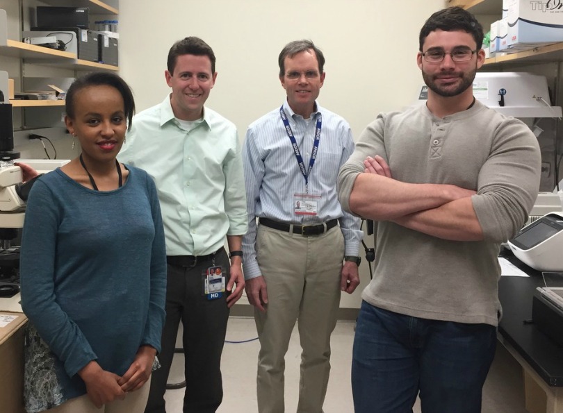 Dr. Adam Green in the lab with his colleagues
